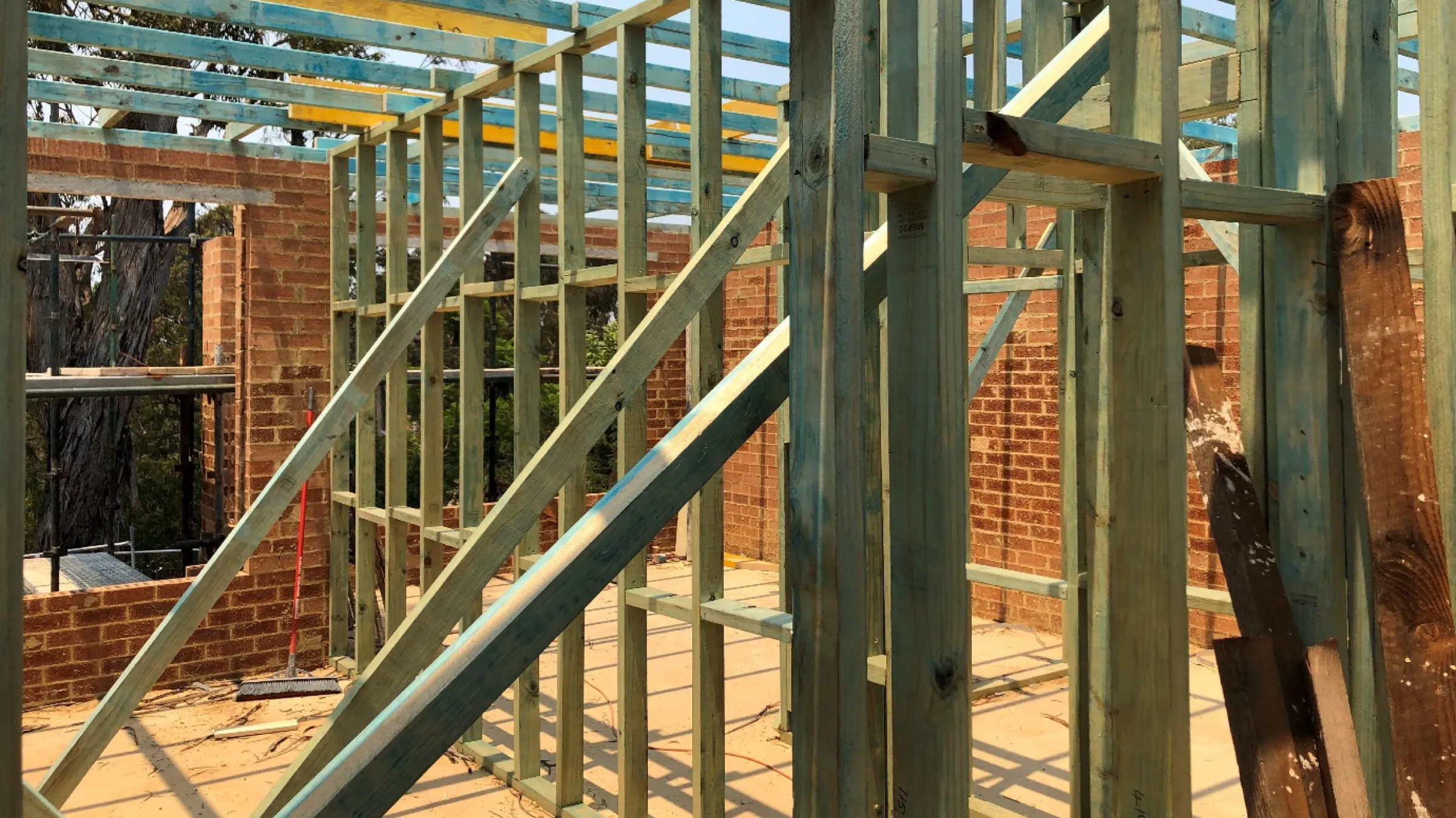 Wall frames and trusses standing on a new brick build